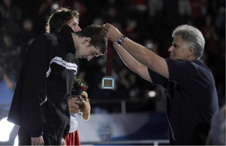 Seven-time Olympic gold medal winner Mark Spitz places a medal on Michael Phelps after the 200m individual medley during the USA 2008 Olympic swim trials